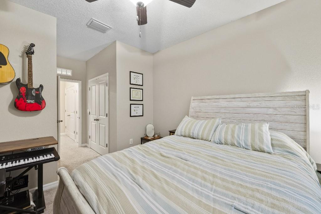 13664 Northwest 9th Road Newberry, FL 32669 - Photo 26 of 33 a bedroom with a bed and a dresser