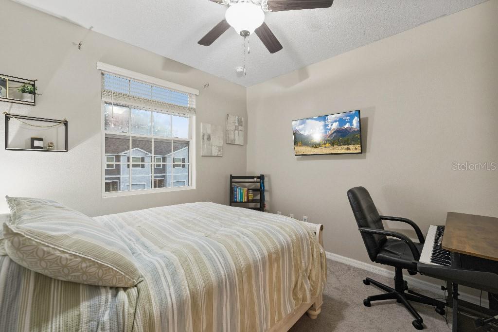 13664 Northwest 9th Road Newberry, FL 32669 - Photo 28 of 33 a bedroom with a bed a desk and chair