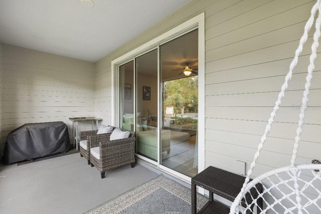 13664 Northwest 9th Road Newberry, FL 32669 - Photo 29 of 33 a living room with furniture and a floor to ceiling window