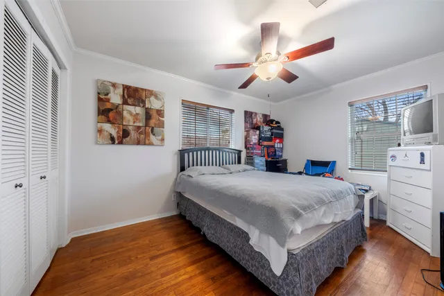 a bedroom with a large bed and a chandelier