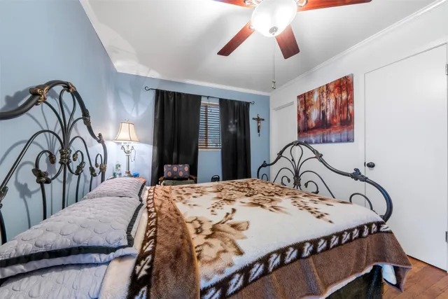 a bedroom with a bed and dresser with mirror