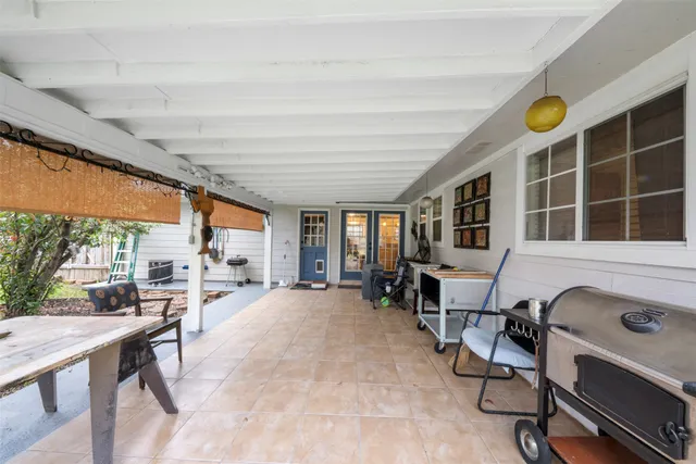 a view of a dining room with furniture a rug and a large window