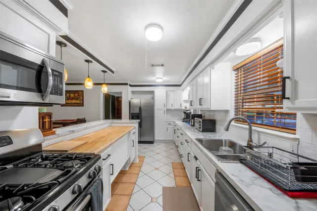 a kitchen with stainless steel appliances granite countertop a stove and a sink