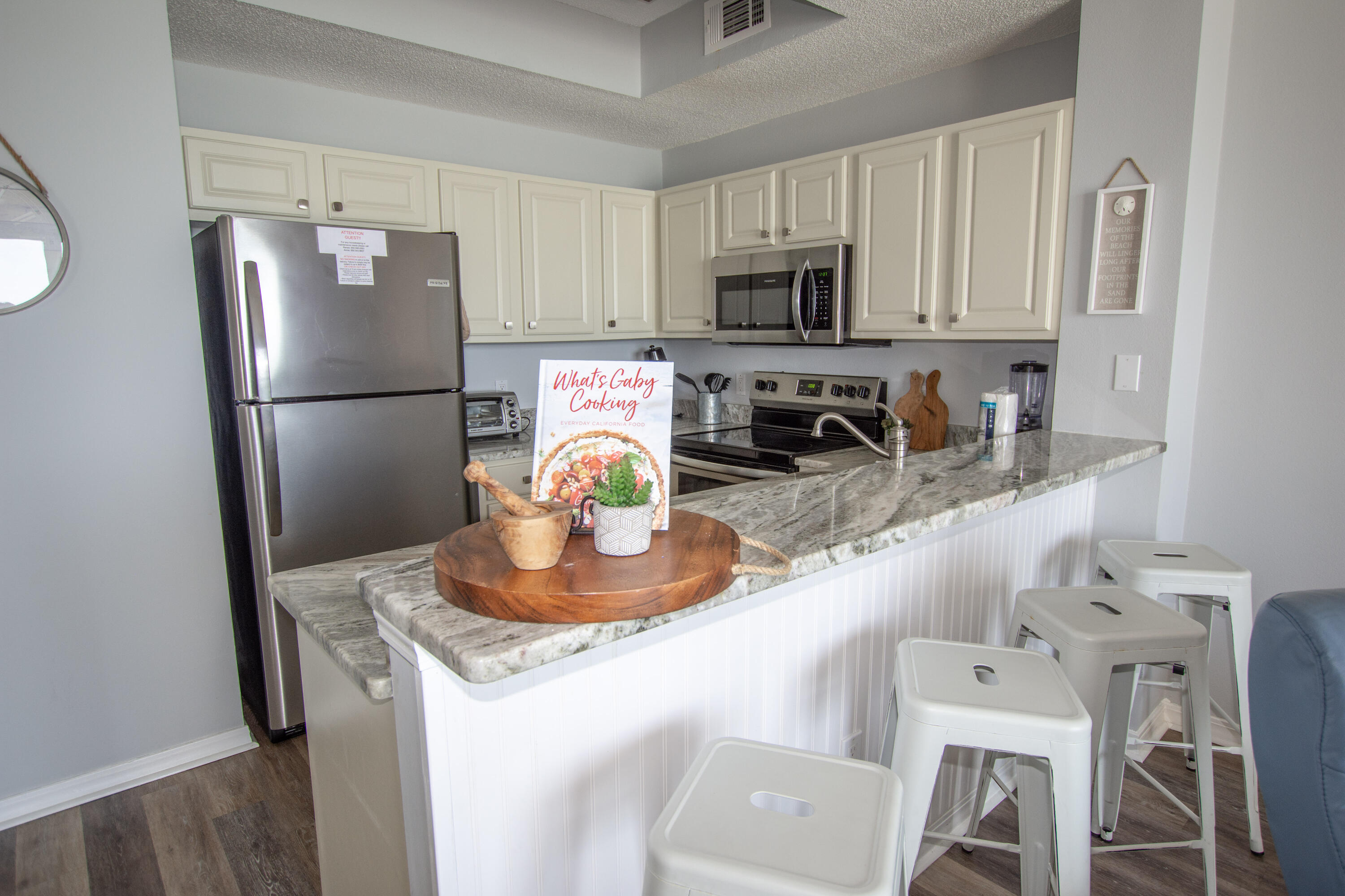 376 Santa Rosa Boulevard, Unit 507 Fort Walton Beach, FL 32548 - Photo 14 of 32 a kitchen with stainless steel appliances granite countertop a sink a refrigerator a stove a microwave and cabinetry