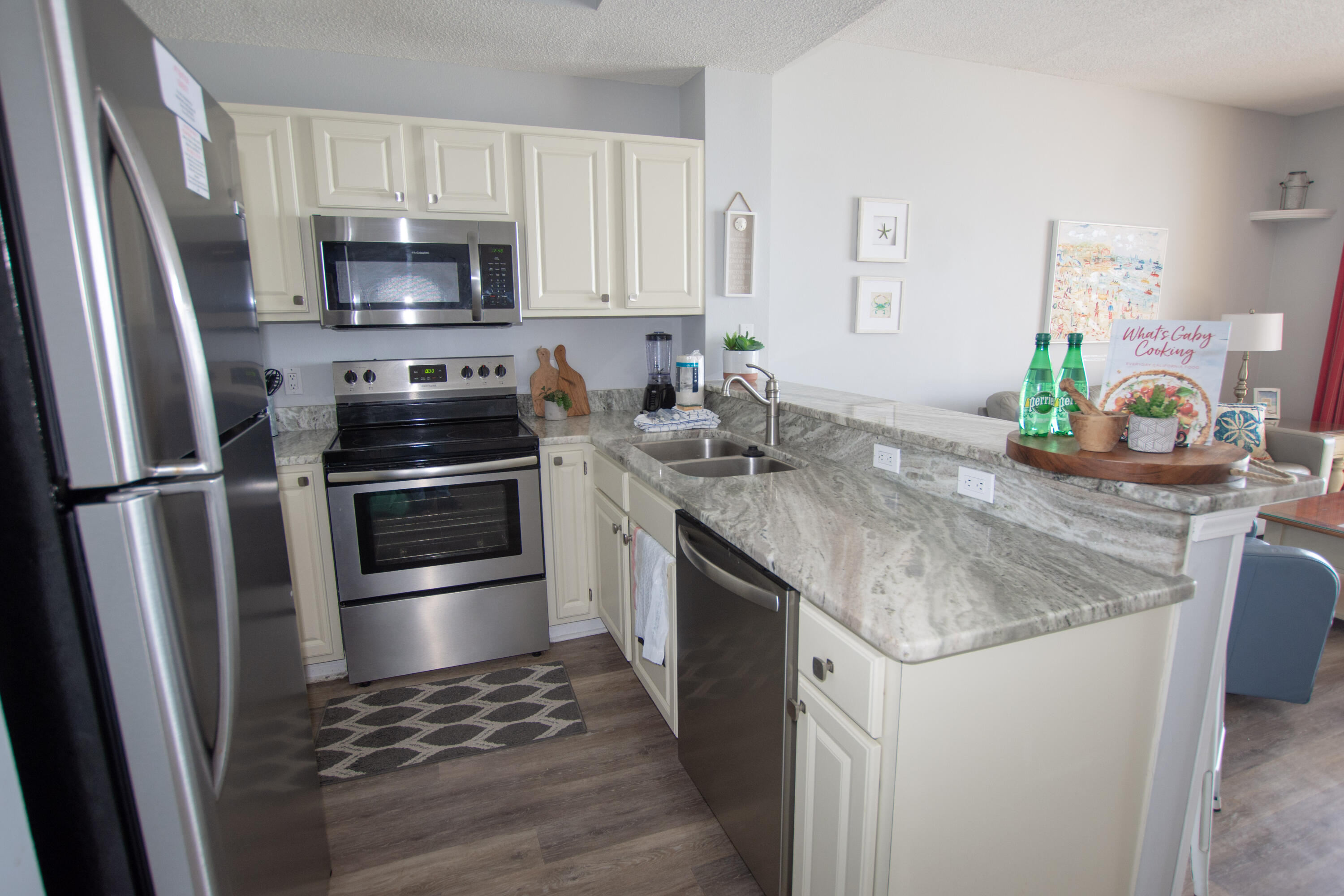 376 Santa Rosa Boulevard, Unit 507 Fort Walton Beach, FL 32548 - Photo 16 of 32 a kitchen with stainless steel appliances granite countertop a sink stove and refrigerator