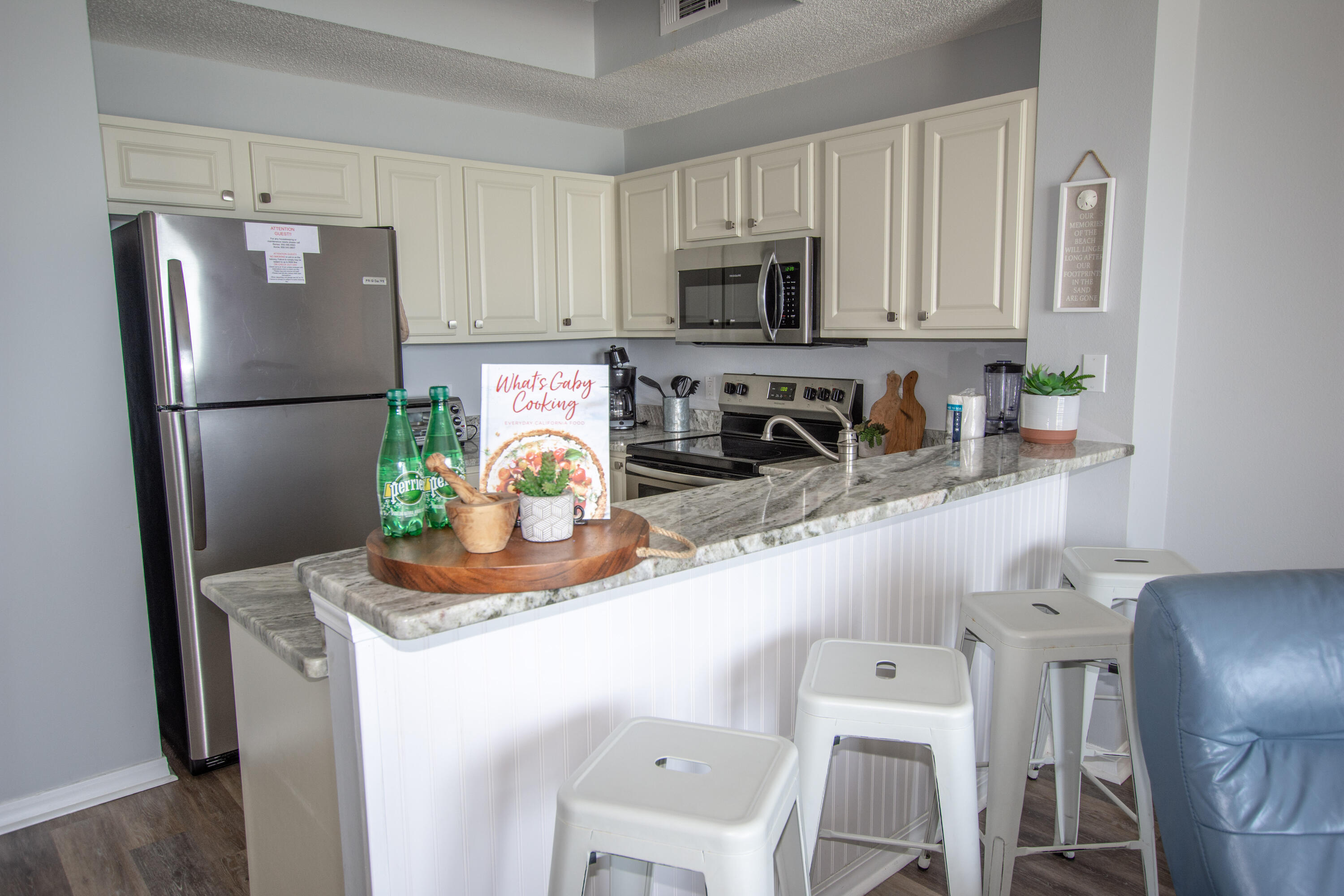 376 Santa Rosa Boulevard, Unit 507 Fort Walton Beach, FL 32548 - Photo 17 of 32 a kitchen with stainless steel appliances a refrigerator a sink a stove a table and chairs