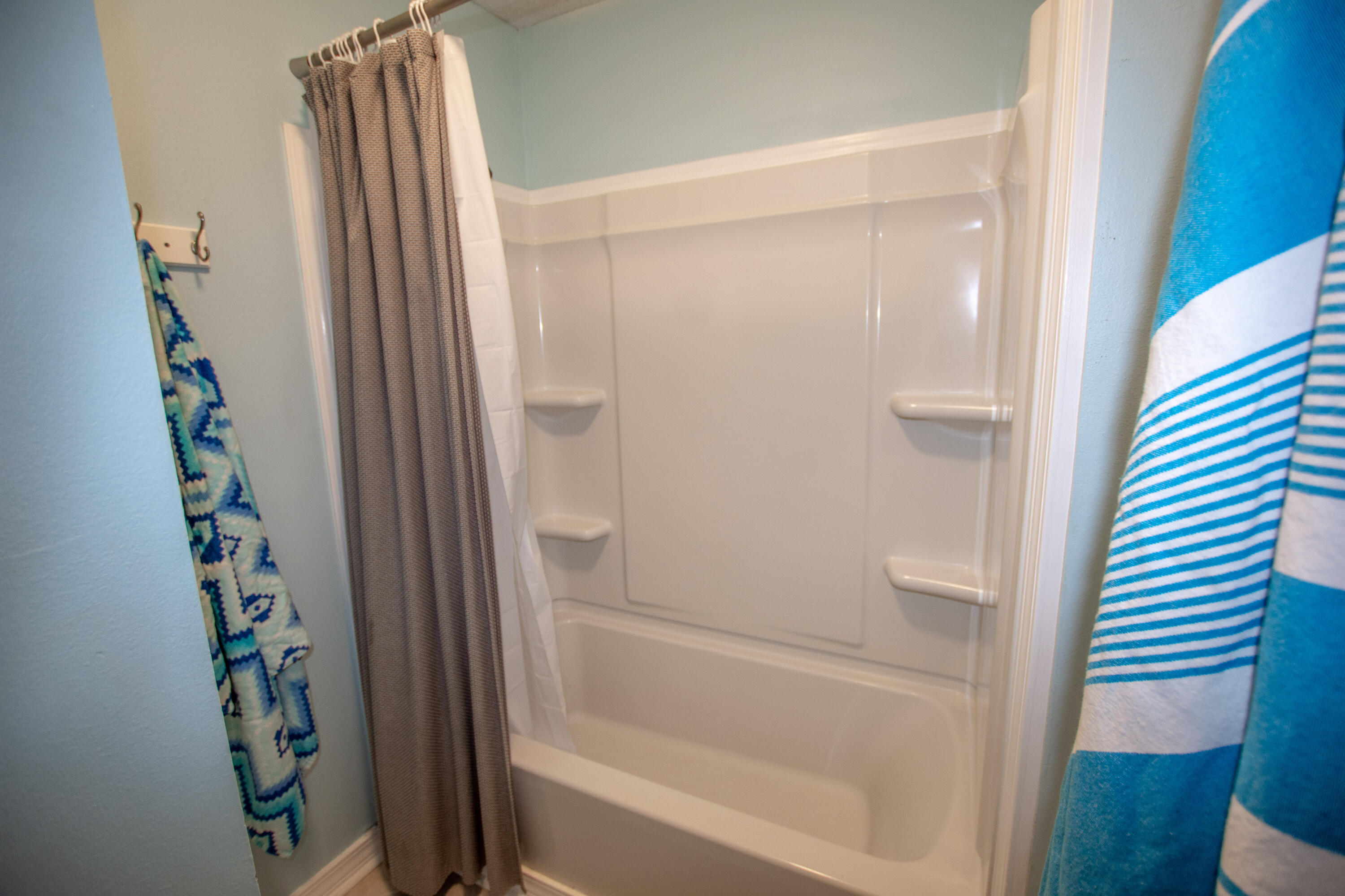 376 Santa Rosa Boulevard, Unit 507 Fort Walton Beach, FL 32548 - Photo 24 of 32 a bathroom with a shower and a mirror