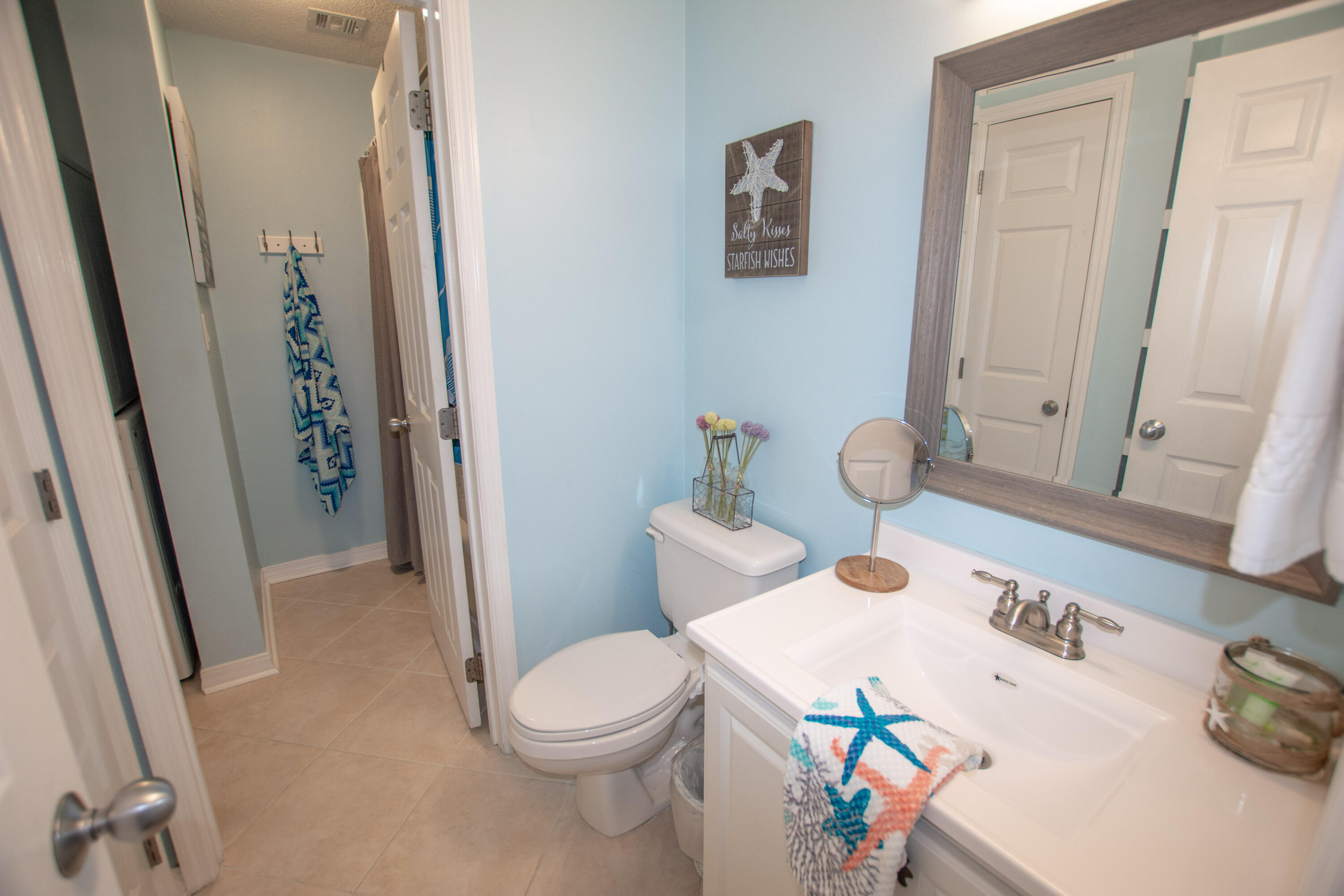 376 Santa Rosa Boulevard, Unit 507 Fort Walton Beach, FL 32548 - Photo 25 of 32 a white toilet sitting next to a bathroom sink