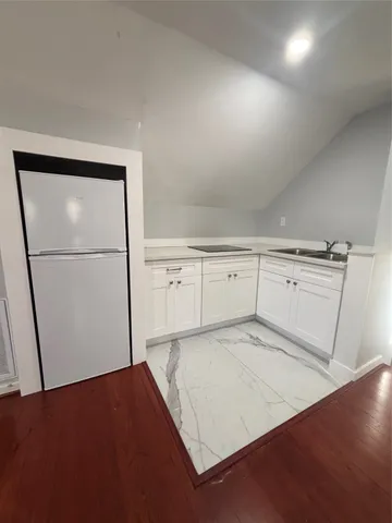 a view of a room with cabinet and mirror