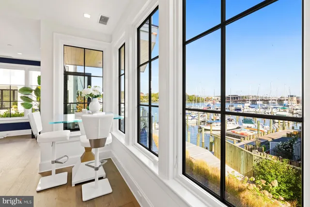 a living room with large windows and furniture