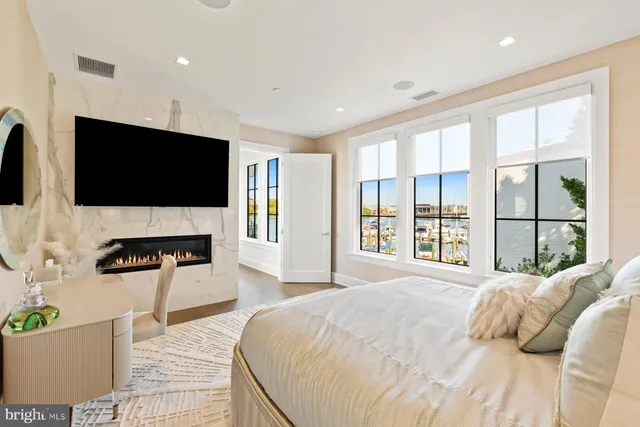 a spacious bedroom with a large bed and a flat screen tv