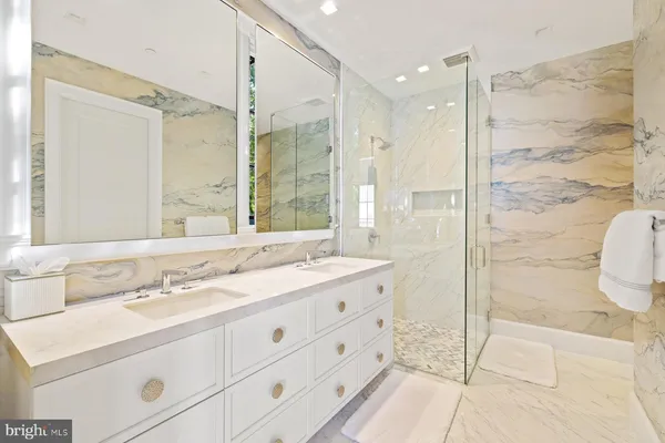 a bathroom with a double vanity sink toilet and shower