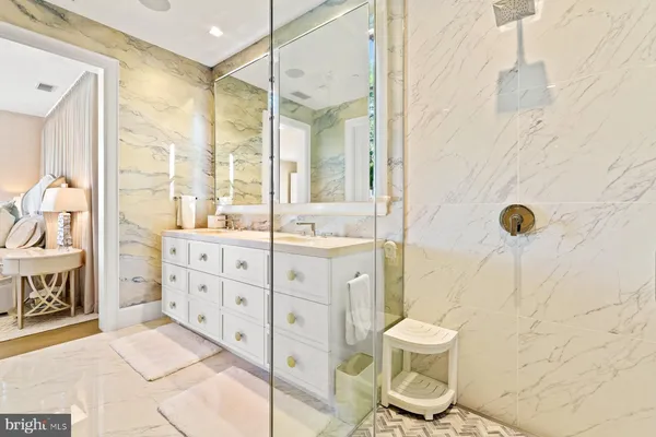 a bathroom with a sink toilet a mirror and shower