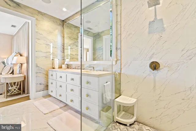 a bathroom with a sink toilet a mirror and shower