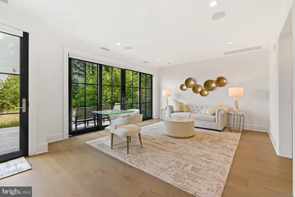 a living room with furniture and a floor to ceiling window