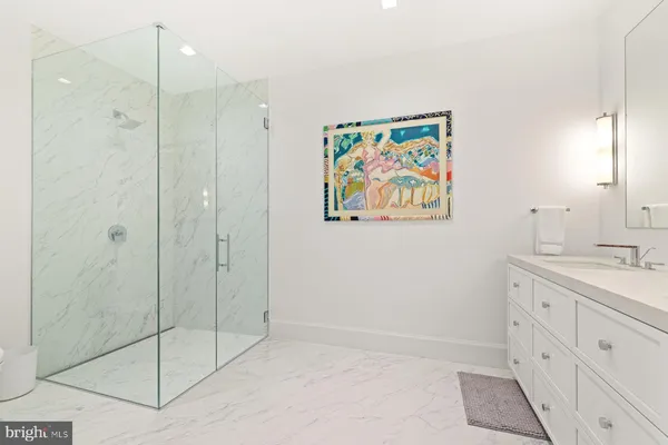 a bathroom with a shower and a sink
