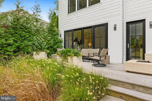 a building outdoor space with patio furniture and potted plants