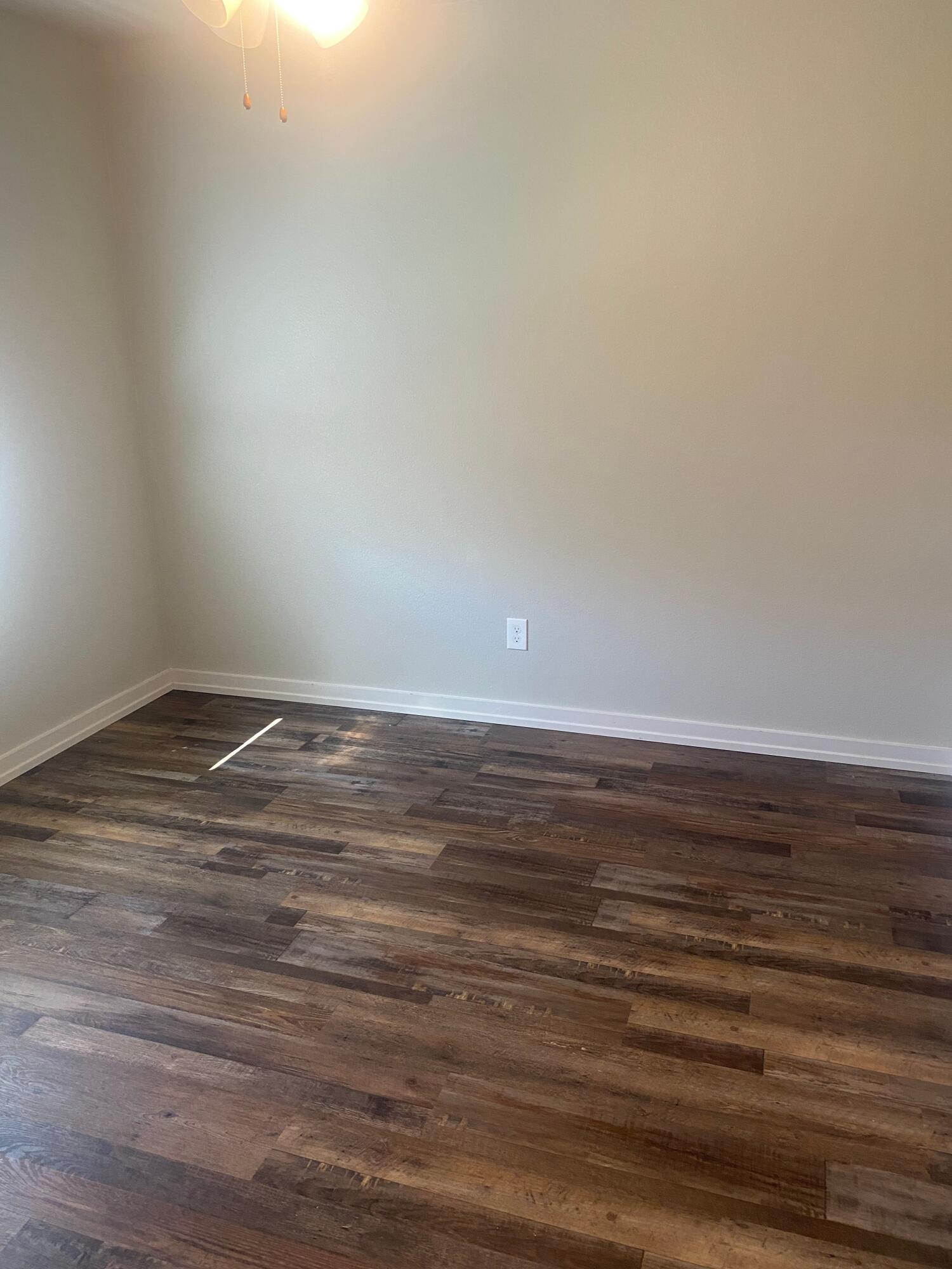 1609 Avenue O, Unit B Shallowater, TX 79363 - Photo 11 of 12 a view of an empty room with wooden floor