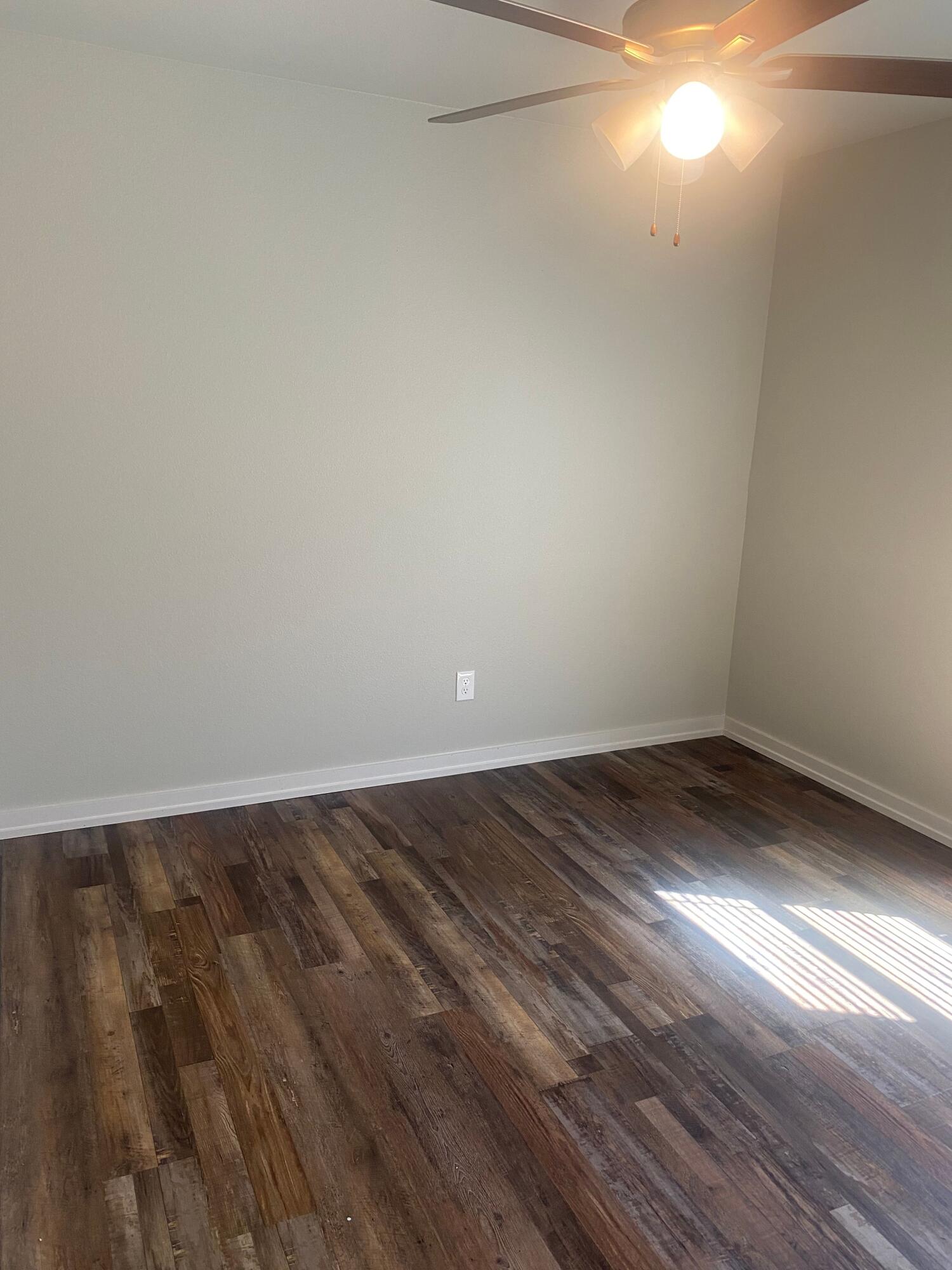 1609 Avenue O, Unit B Shallowater, TX 79363 - Photo 9 of 12 a view of empty room with wooden floor and fan
