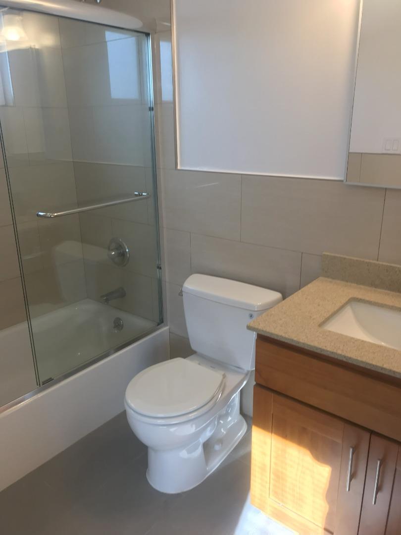 2469 Olive Avenue San Jose, CA 95128 - Photo 6 of 10 a white toilet sitting next to a bath tub and shower