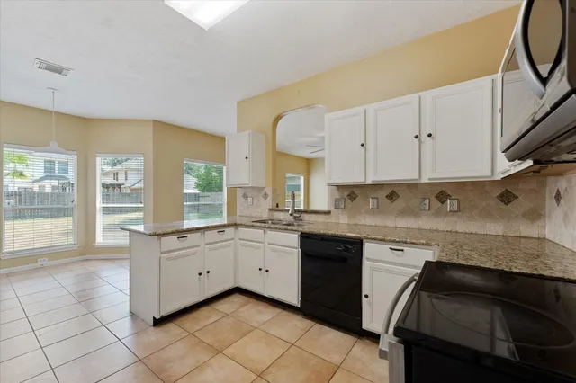 a kitchen with a sink stove and microwave