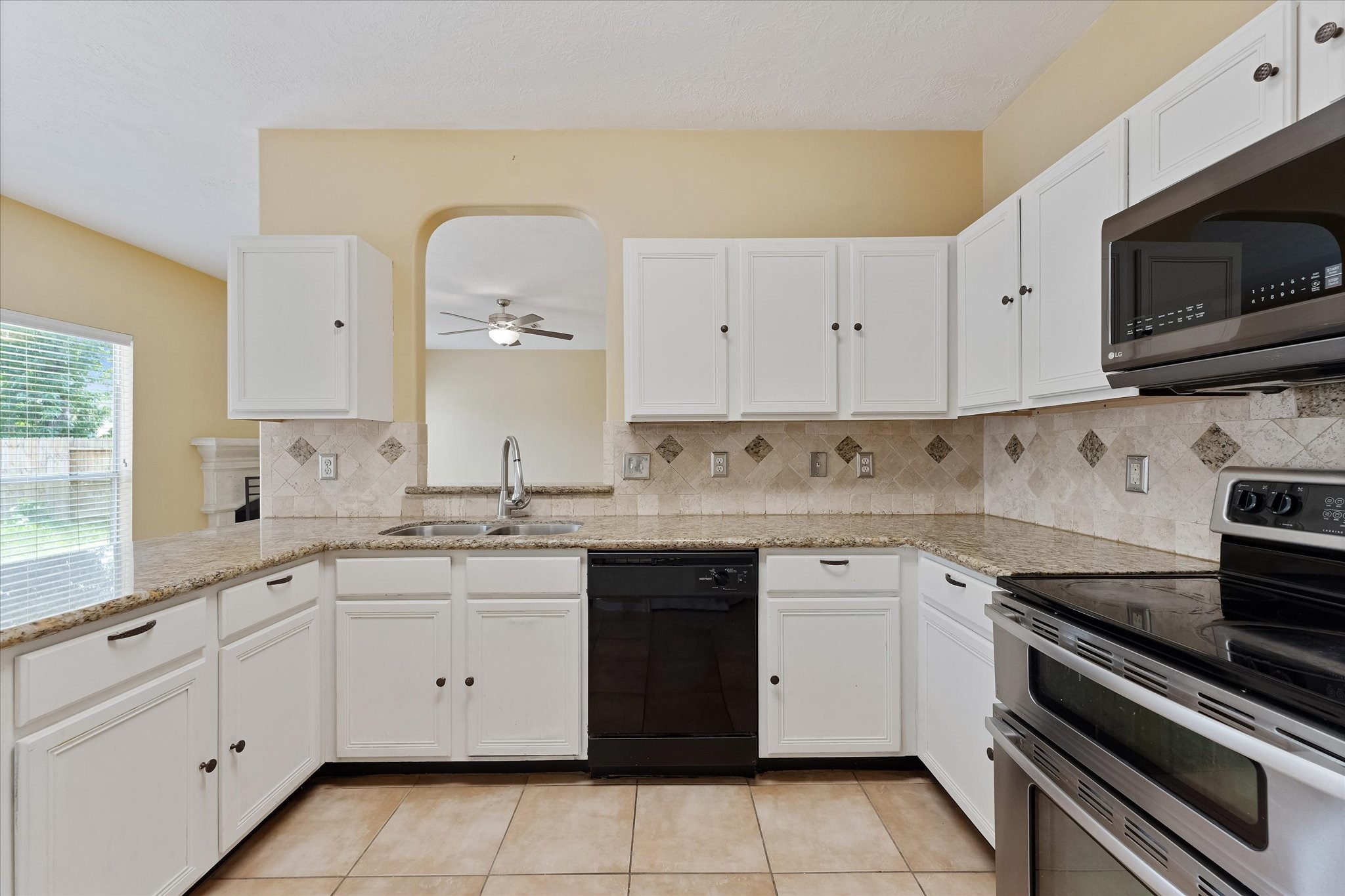 23806 Spring Way Drive Spring, TX 77373 - Photo 14 of 44 a kitchen with a sink stove and microwave