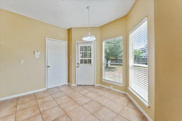a view of an empty room with a ceiling fan