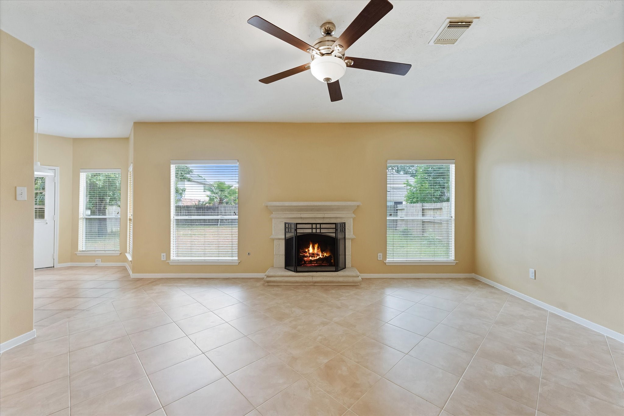 23806 Spring Way Drive Spring, TX 77373 - Photo 19 of 44 a view of a livingroom with a fireplace and a ceiling fan