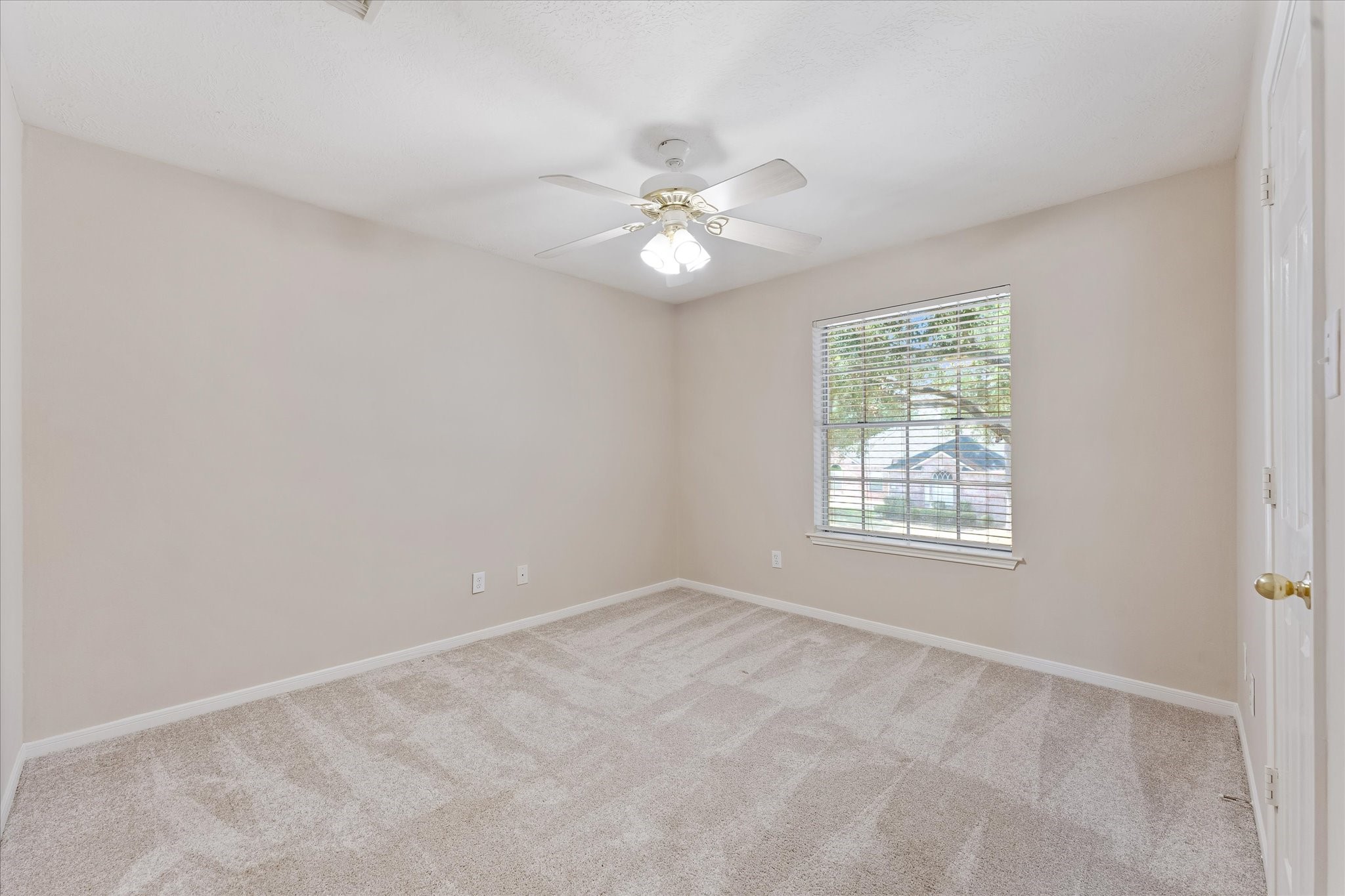 23806 Spring Way Drive Spring, TX 77373 - Photo 21 of 44 an empty room with a window and a fan