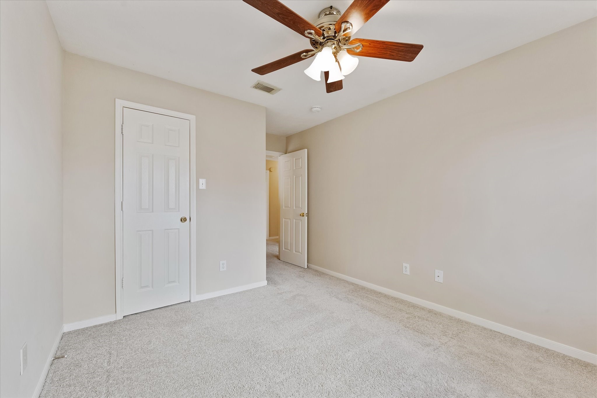 23806 Spring Way Drive Spring, TX 77373 - Photo 26 of 44 an empty room with a chandelier fan and a ceiling fan