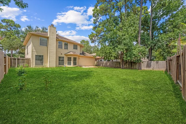 a view of a swimming pool with a yard and seating area