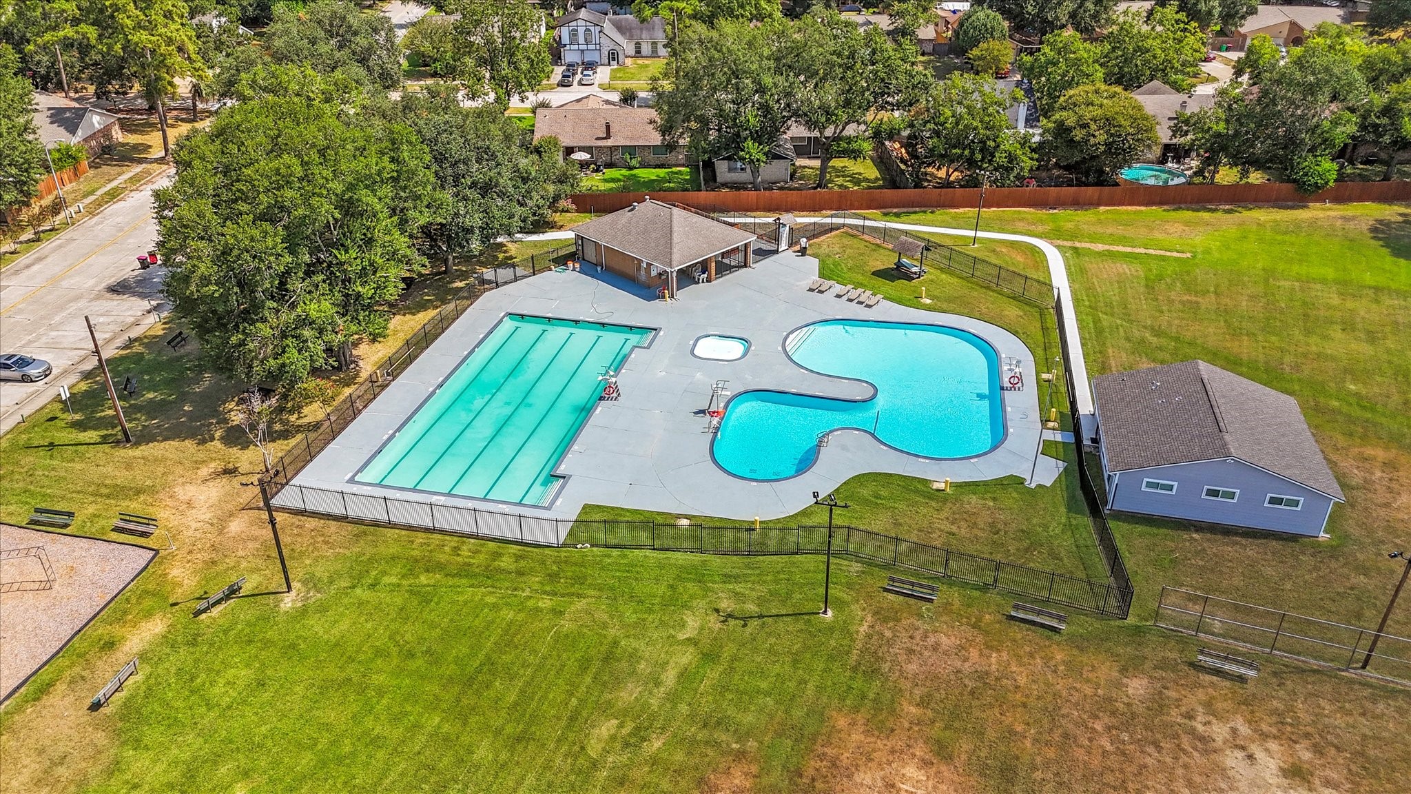 23806 Spring Way Drive Spring, TX 77373 - Photo 41 of 44 a view of a swimming pool with a yard and seating area