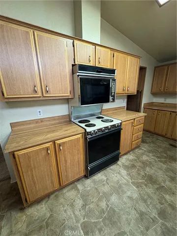 a kitchen with stainless steel appliances granite countertop a stove a sink dishwasher and a refrigerator