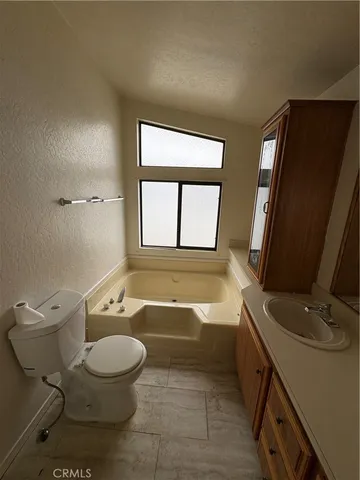a bathroom with a toilet a sink and a bathtub
