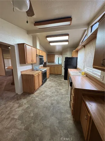 a kitchen with a stove a refrigerator and a sink