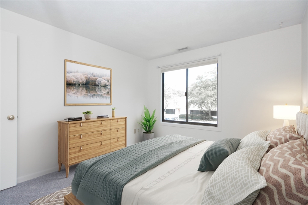 8 Concord Greene, Unit 4 Concord, MA 01742 - Photo 11 of 42 a bedroom with a bed and a window