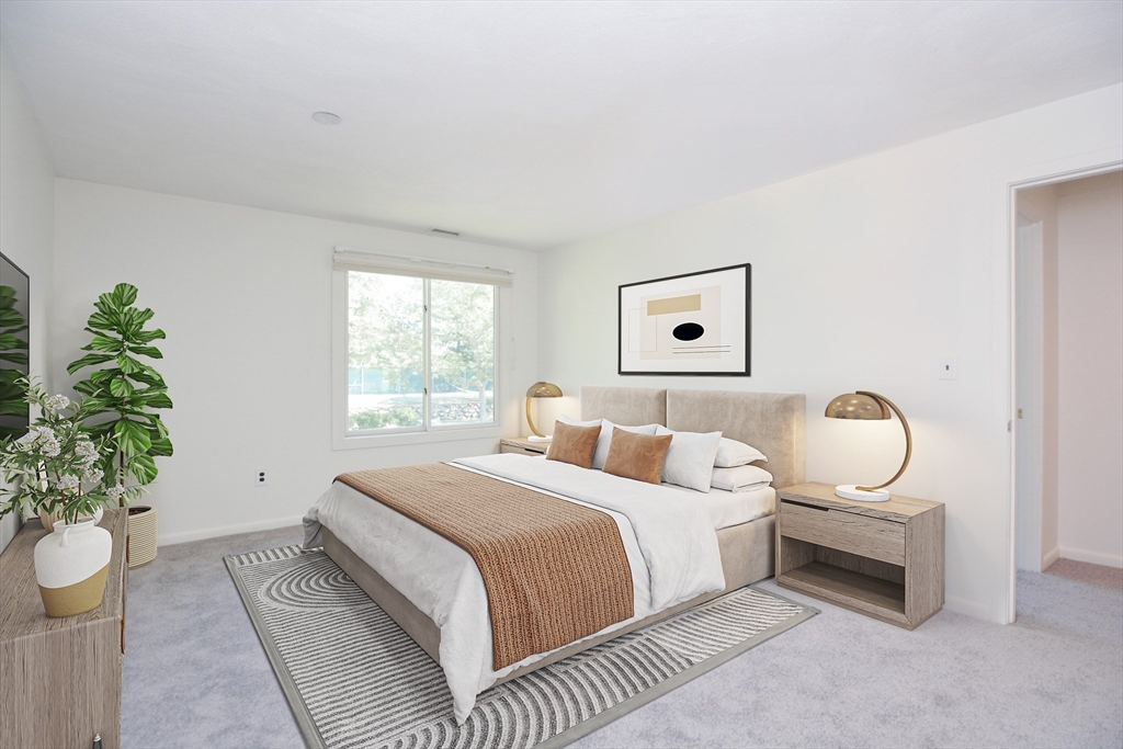 8 Concord Greene, Unit 4 Concord, MA 01742 - Photo 15 of 42 a bedroom with a bed and a potted plant