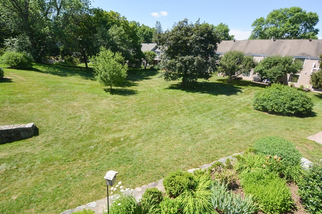 8 Concord Greene, Unit 4 Concord, MA 01742 - Photo 25 of 42 a yellow building with trees in front of it