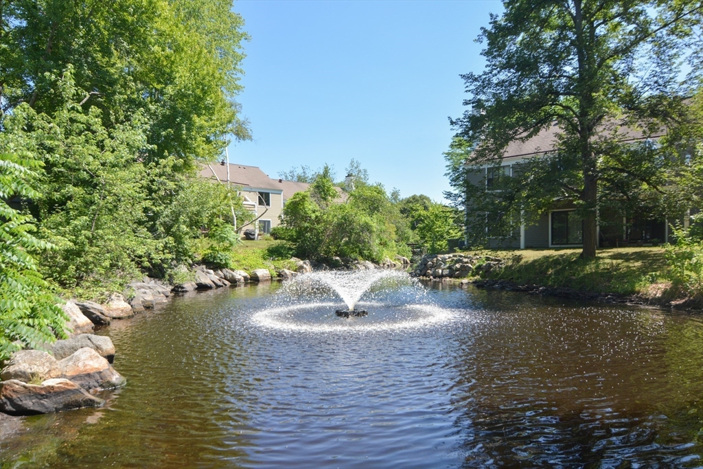 8 Concord Greene, Unit 4 Concord, MA 01742 - Photo 35 of 42 a view of a lake with a yard