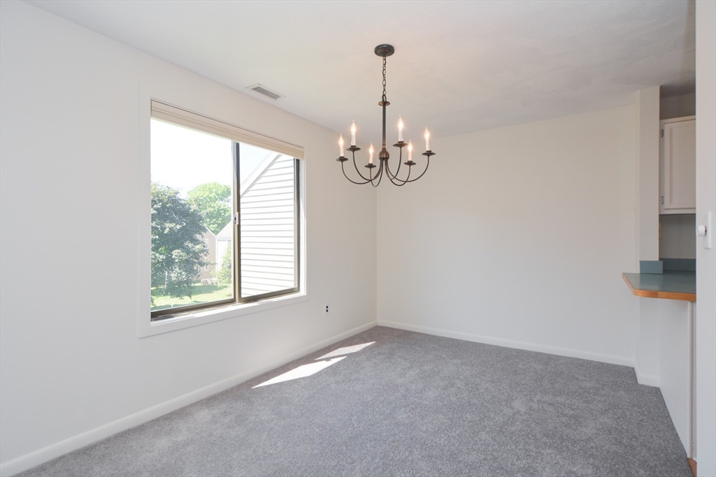 8 Concord Greene, Unit 4 Concord, MA 01742 - Photo 8 of 42 a view of a room with windows and chandelier