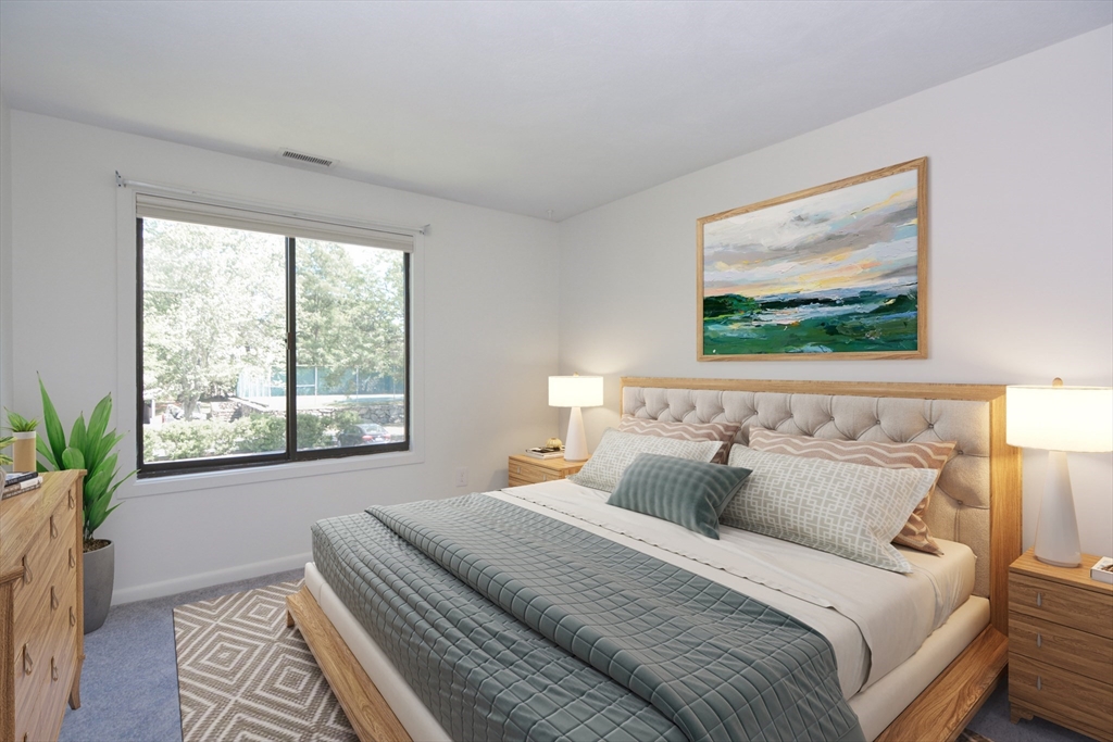 8 Concord Greene, Unit 4 Concord, MA 01742 - Photo 9 of 42 a bedroom with a large bed and a painting on the wall