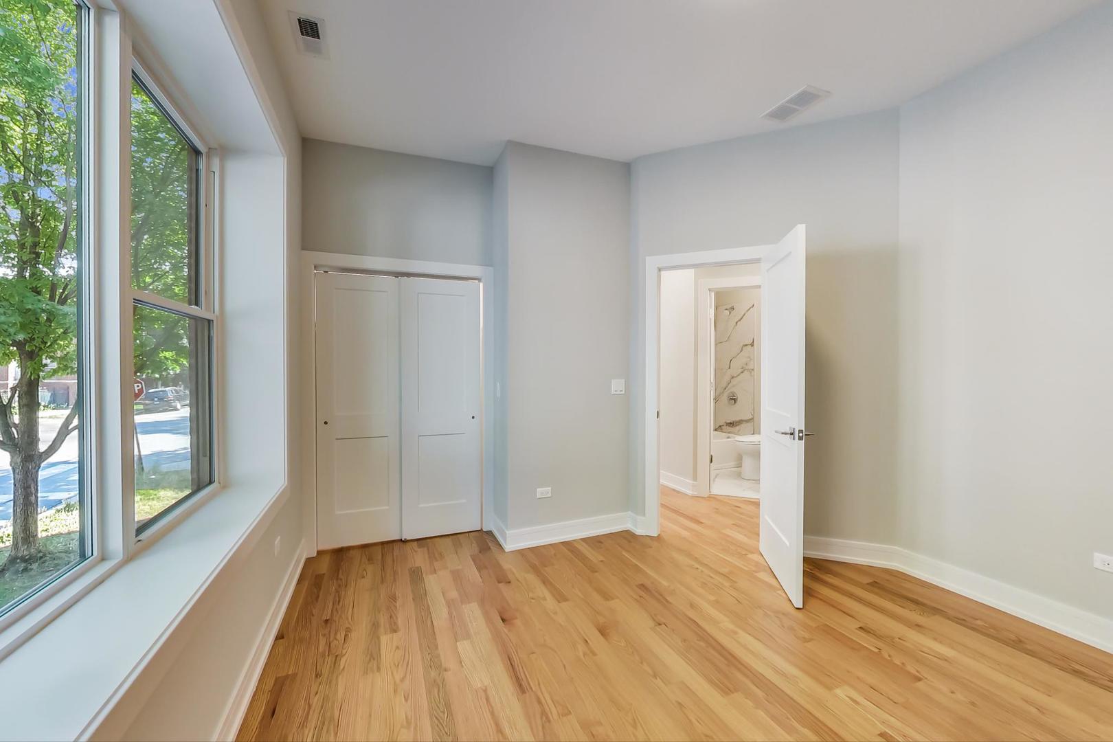 3534 West Wrightwood Avenue, Unit 1F Chicago, IL 60647 - Photo 13 of 18 a view of empty room with wooden floor and fan