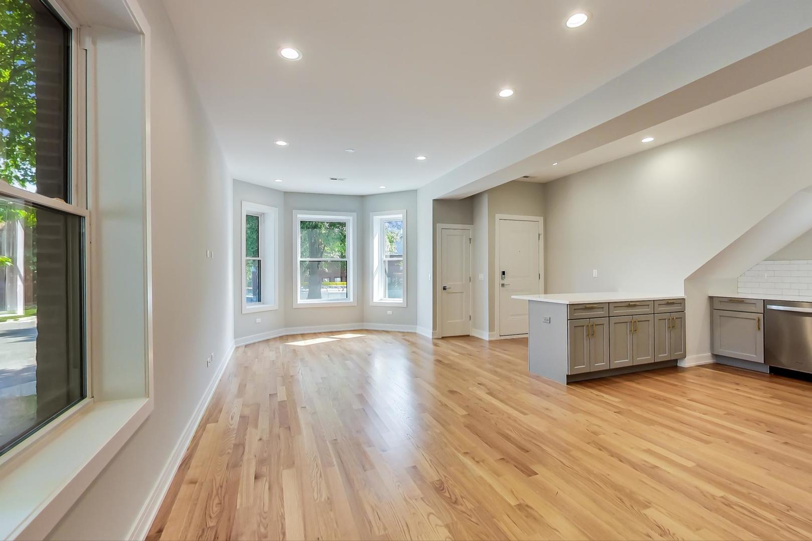3534 West Wrightwood Avenue, Unit 1F Chicago, IL 60647 - Photo 4 of 18 a view of empty room with wooden floor