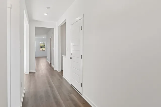 a view of a hallway with wooden floor