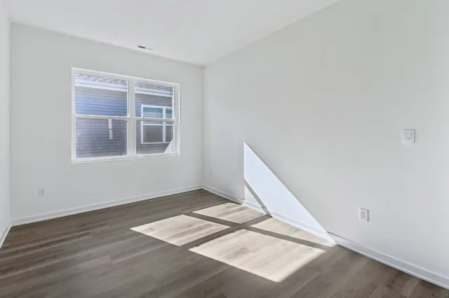 a view of an empty room and wooden floor
