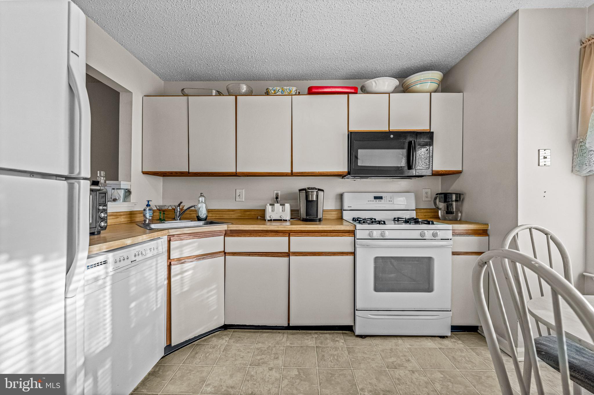 656 Covington Court Sewell, NJ 08080 - Photo 14 of 26 a kitchen with stainless steel appliances granite countertop a stove and white cabinets