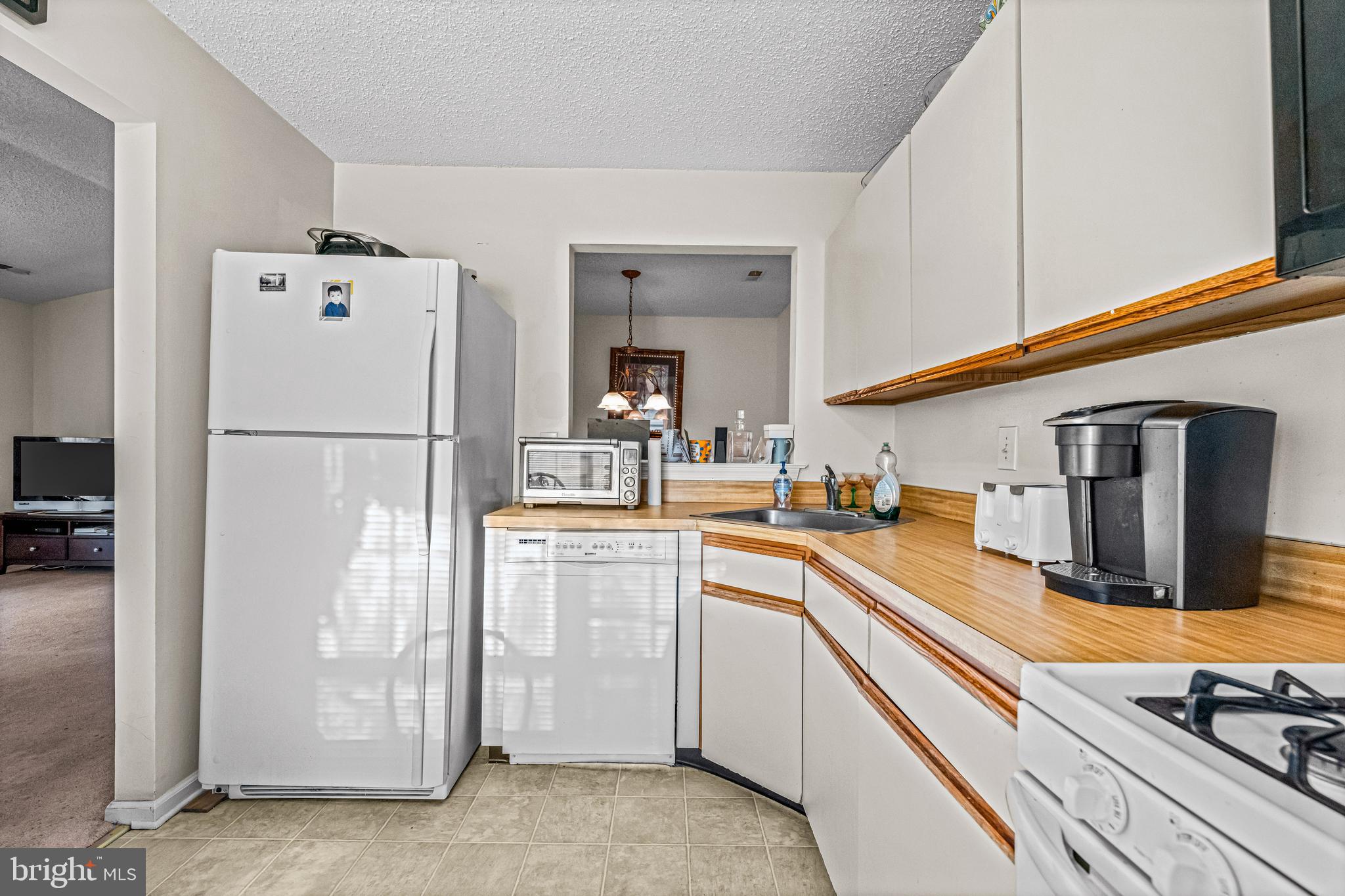 656 Covington Court Sewell, NJ 08080 - Photo 16 of 26 a kitchen with refrigerator and cabinets