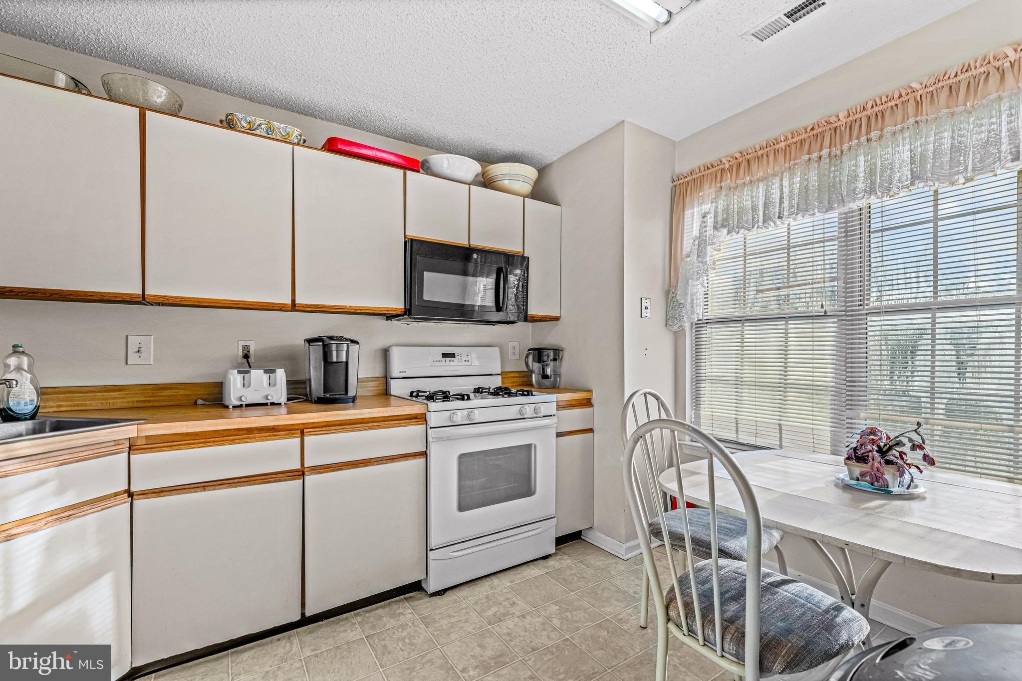 656 Covington Court Sewell, NJ 08080 - Photo 18 of 26 a kitchen with stainless steel appliances granite countertop a sink a stove and a microwave