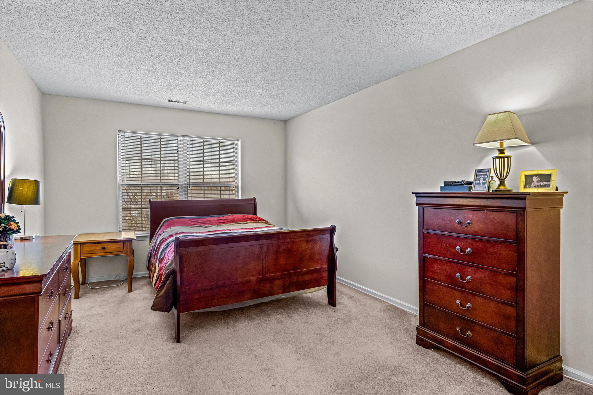 656 Covington Court Sewell, NJ 08080 - Photo 19 of 26 a bedroom with a bed and a dresser in it