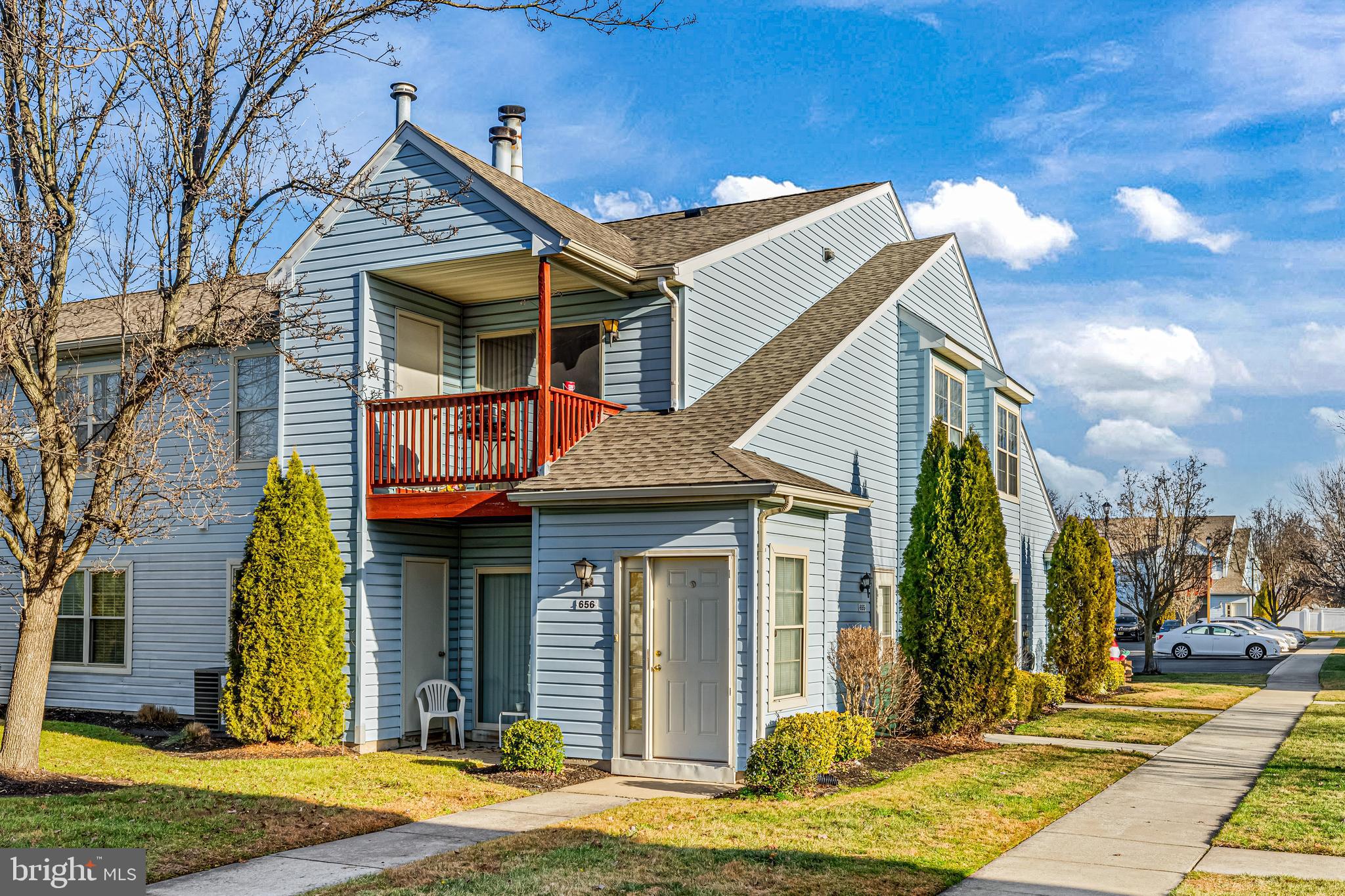 656 Covington Court Sewell, NJ 08080 - Photo 2 of 26 a view of a white house with large windows and a table and chairs